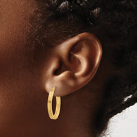 Load image into Gallery viewer, 10K Polished and Grooved Oval Hoop Earrings
