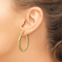 Load image into Gallery viewer, 10k Polished and Textured Twisted Tube Hoop Earrings
