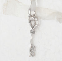 Load image into Gallery viewer, Sterling Silver Womens Round Diamond Heart Key Pendant 1/8 Cttw
