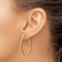 Load image into Gallery viewer, 14k Polished and Textured Twisted Tube Hoop Earrings

